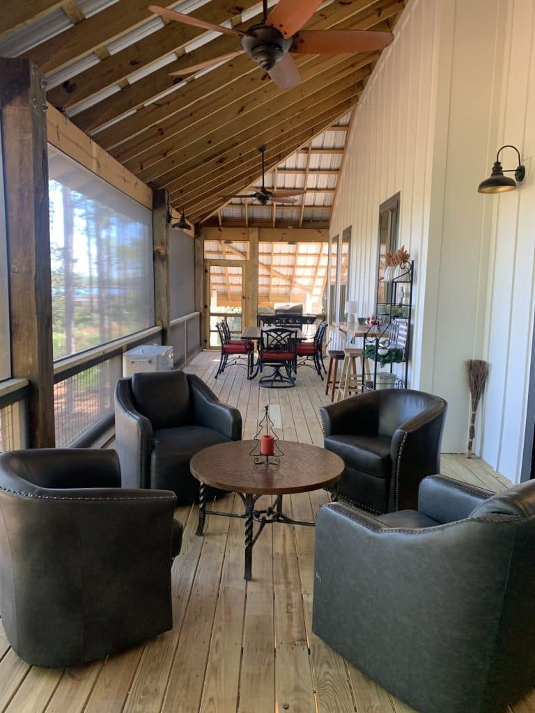 Inside of a custom home build by JC Homes & Development on the rural coast of the Florida panhande with open wood ceiling and screened in porch