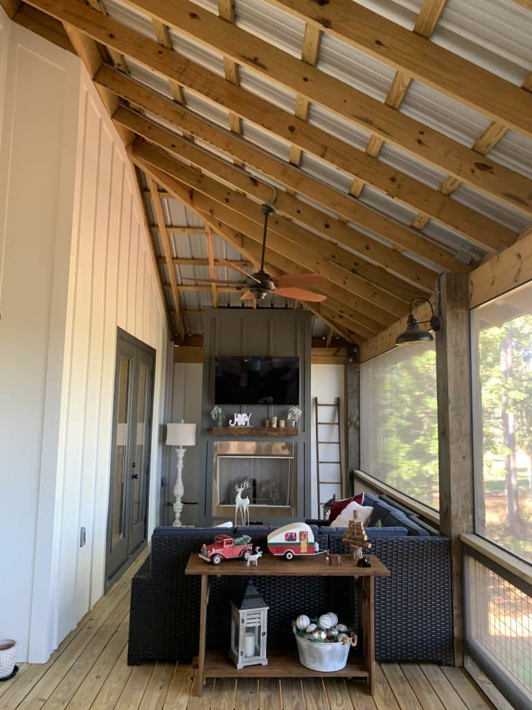 Inside of a custom home build by JC Homes & Development on the rural coast of the Florida panhande with open wood ceiling and screened in porch